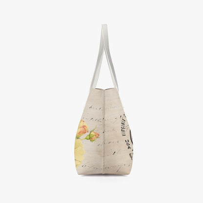VCMCo. Born and Raised in Nevada vegan leather tote bag — side edge angle view showing structured shape, silver handles, and floral motorcycle graphic with script detailing