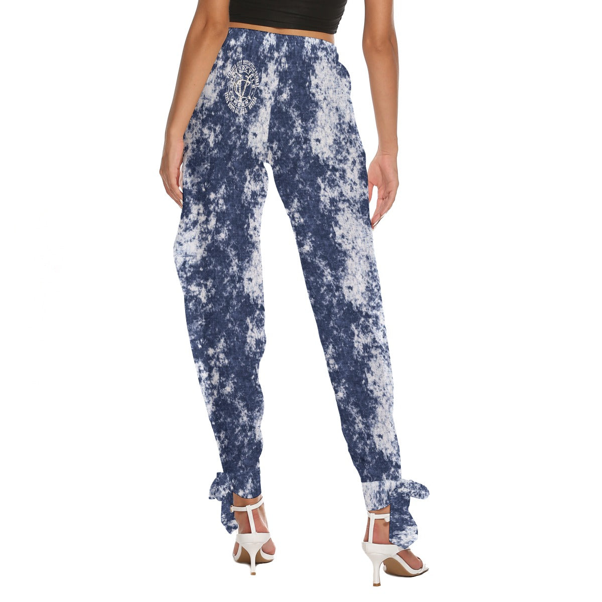 Back Side view of "I Tell My Evil Where to Fly" navy acid-wash side cutout pants with ankle strap ties and VCMCo. eagle skull biker graphic — women's motorcycle apparel