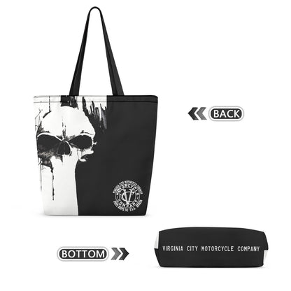 Black and white tote bag with a skull graphic and a circular Virginia City Motorcycle Company logo, shown alongside a matching black pouch labeled Virginia City Motorcycle Company, on a white background with orientation labels.