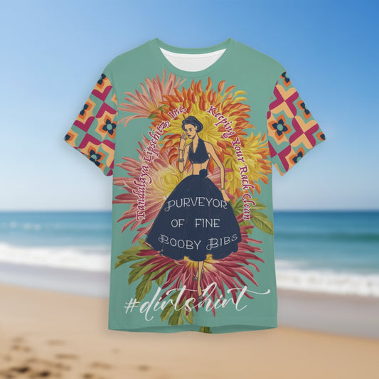 a teal Tandalaya Lipschitz #dirtshirt short sleeve tee, hovering over a blurred beach scene — VCMCo.
